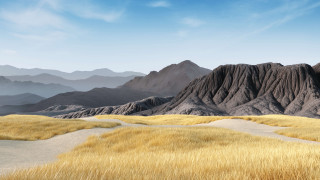 Mountain range grassy field blue 2 - a grassy field in the foreground free wallpaper