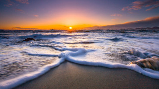 Sunset ocean waves rock beach - a sunset over the ocean free wallpaper