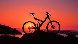 Bike rock sunset ocean person - the background and a person free wallpaper