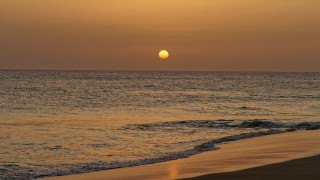 Sunset ocean beach waves boat - the foreground and a boat in the distance free wallpaper