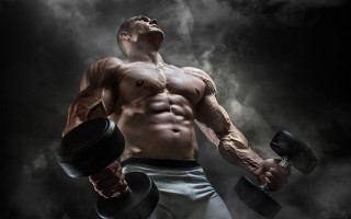 Muscular man dumbbells smokey background - masculine free wallpaper