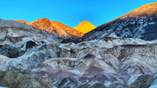Mountain range yellow peak blue - a blue sky in the background free wallpaper for desktop