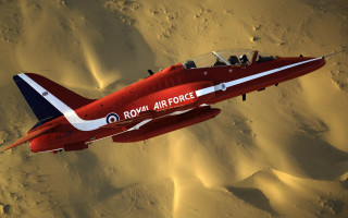 Red fighter jet desert sand - over a desert landscape free wallpaper