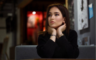 Woman sitting serious brown hair - a woman sitting free wallpaper