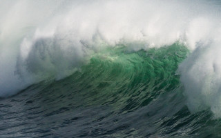 Large wave crashing over surfer - in the ocean free wallpaper