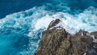 Rocky cliff water foreground beach - a rocky cliff free wallpaper