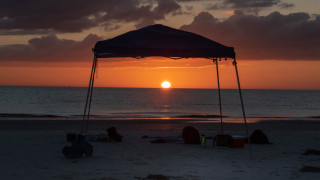 Sunset beach tent people lighthouse - free sunset wallpaper for desktop