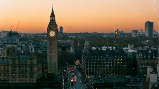 City clocktower street cars sunset - a city skyline in the background free wallpaper