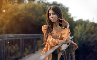 Woman leaning on rail serious - the camera free wallpaper for desktop