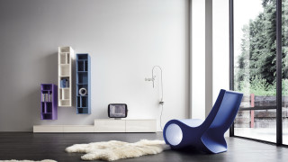 Blue chair white rug bookshelf - bold shape free wallpaper