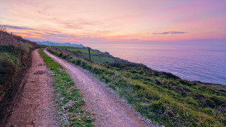 Dirt road hill ocean sunset - in the foreground free wallpaper for desktop
