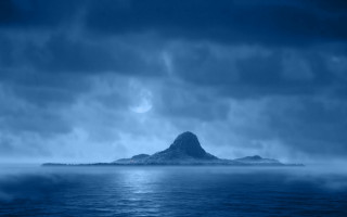 Large island moonlit ocean beach - a full moon in the distance free wallpaper