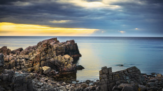 Rocky outcropping ocean clouds sunbeam - a cloudy sky above free wallpaper