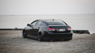 Black car gravel road ocean - a gravel road next free wallpaper
