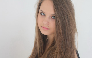 Woman long hair portrait white - a white wall behind her free wallpaper for desktop