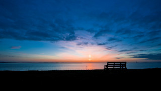 Beach bench sunset blue sky - a sunset in the distance free wallpaper