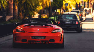 Red sports car driving black - ahmed yacoubi free wallpaper