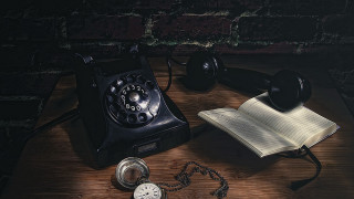 Phone book pocketwatch table brickwall - a brick wall in the background free wallpaper