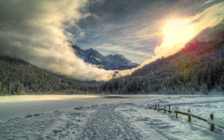 Snowy mountain lake fence reflection - a mountain in the background and a lake in the foreground free wallpaper