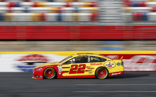 Racecar track blurry stadium red - a race car free wallpaper