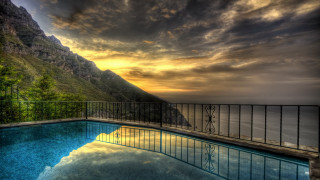 Sunset mountain reflection pool cityscape - a body of water below free wallpaper