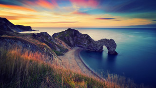 Sunset ocean rock beach landscape - a beautiful sunset over the ocean free wallpaper