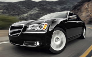 Black car mountains cloudy sky - a black car free wallpaper