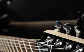 Guitar neck closeup black background 4 - a close up of a guitar neck free wallpaper