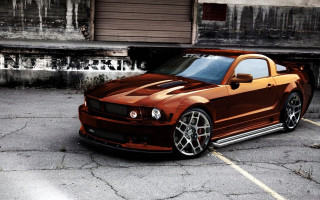 Brown mustang parking lot building - a garage door open free wallpaper