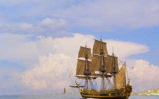 Sailboat ocean cloudy sky lighthouse - under free wallpaper