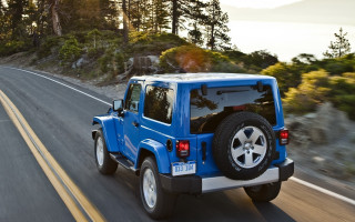 Blue jeep driving forest hillside - both side of the road free wallpaper