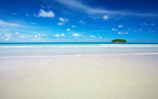 Sandy beach island blue sky - a small island in the distance free wallpaper