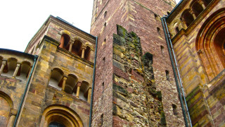 Tall brick building clock roman - face and a clock free wallpaper