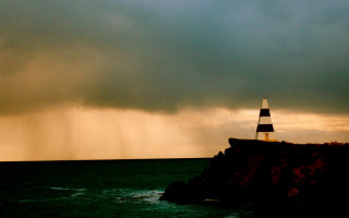 Lighthouse cliff stormy sky lightning - a dark sky in the background free wallpaper