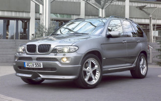 Silver car clock building parking - a silver car free wallpaper for desktop