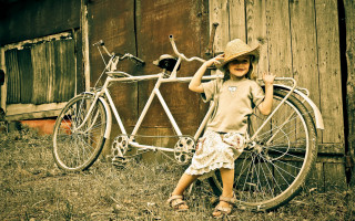 Young girl bicycle barn hat - free retro wallpaper