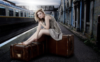 Woman sitting suitcase train station - the track free wallpaper