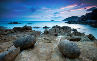Rocky beach dusk purple sky - a purple sky in the background free wallpaper
