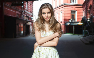 Serious woman street crossed arms - a woman in a dress free wallpaper for desktop