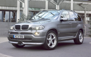 Silver car building clock parking - a silver car free wallpaper for desktop