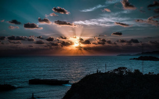 Sunset ocean clouds boat hill - crepuscular free wallpaper