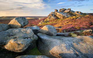 Rocky landscape tilt shift mountains - a grassy area in the background free wallpaper