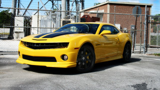 Yellow sports car parking lot 16 - a fence and a building free wallpaper