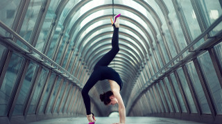 Woman handstand glass tunnel ballet - symmetric balance free wallpaper