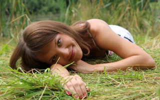 Girl field grass laying anna - the ground in a field of grass free wallpaper