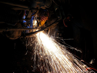 Person welding metal sparks light - auto free wallpaper