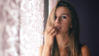 Woman brushing teeth window curtain - a curtain behind her free wallpaper