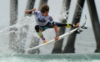 Surfing woman wave pier space - evan charlton free wallpaper