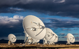 Satellite dishes mountains cloudy sky - free technology wallpaper