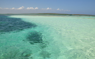 Ocean island boat sky waves - carpoforo tencalla free wallpaper
